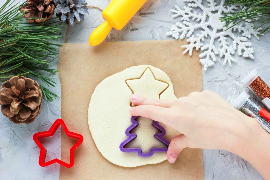 cut out a toy from salt dough on a Christmas tree with our own hands